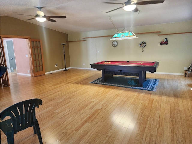 game room featuring hardwood / wood-style floors, vaulted ceiling, and ceiling fan