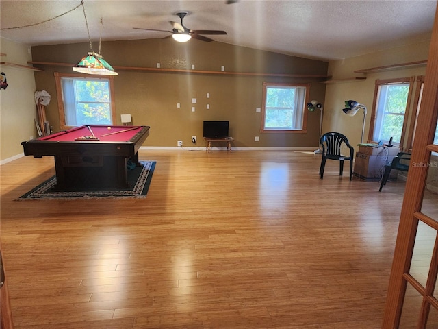 game room featuring light hardwood / wood-style floors, a healthy amount of sunlight, ceiling fan, and vaulted ceiling