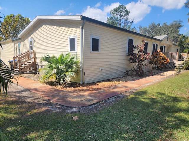 view of side of home with a yard