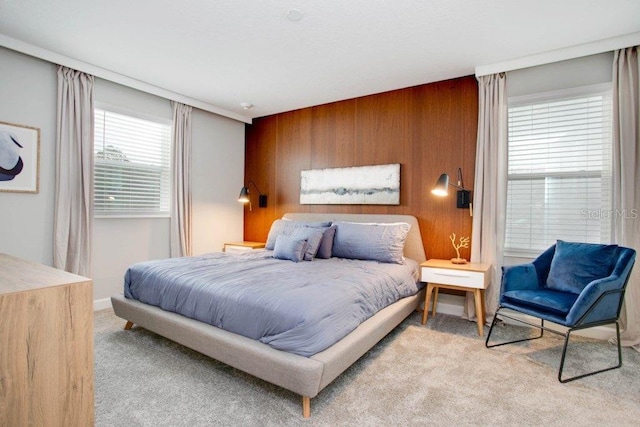 carpeted bedroom with wood walls