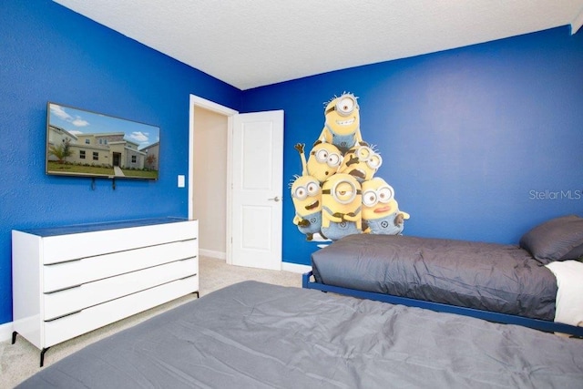 bedroom featuring a textured ceiling and carpet