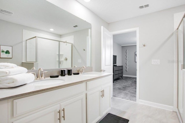 bathroom with an enclosed shower and vanity