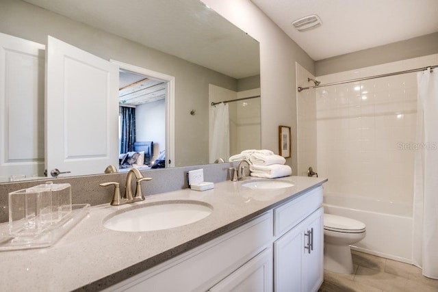 full bathroom with tile patterned floors, shower / bath combo, vanity, and toilet