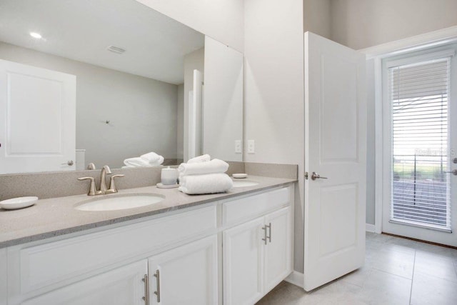 bathroom with tile patterned flooring and vanity