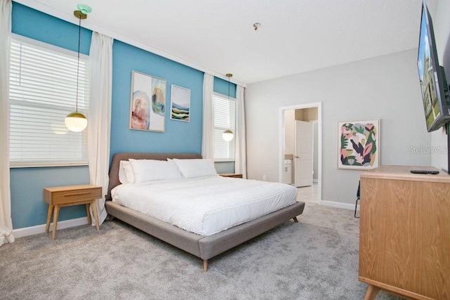 bedroom featuring light carpet and multiple windows