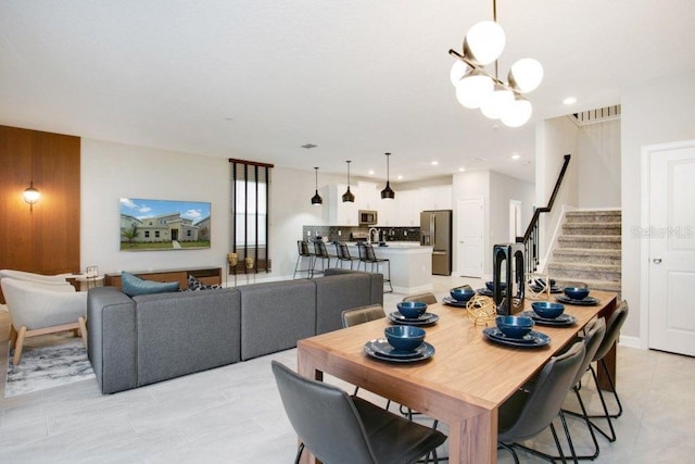 tiled dining area featuring a notable chandelier