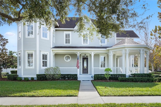 view of front of property with a front lawn and covered porch