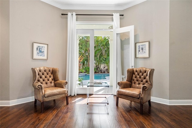 living area featuring ornamental molding, a healthy amount of sunlight, and dark hardwood / wood-style flooring