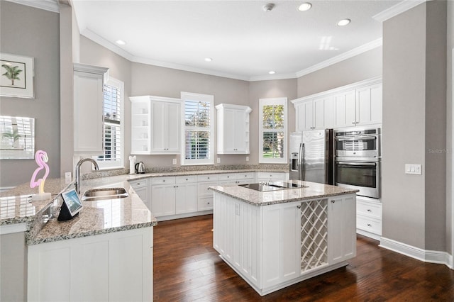 kitchen with sink, kitchen peninsula, appliances with stainless steel finishes, dark hardwood / wood-style floors, and light stone countertops