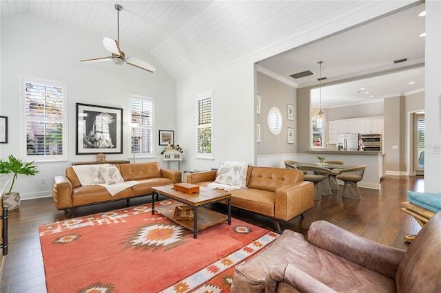 living room with ceiling fan, plenty of natural light, and dark hardwood / wood-style floors