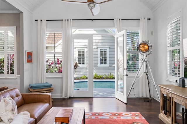 doorway to outside featuring lofted ceiling, ornamental molding, dark hardwood / wood-style flooring, and ceiling fan