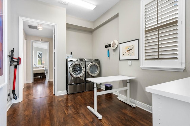 washroom with dark hardwood / wood-style floors and washing machine and clothes dryer