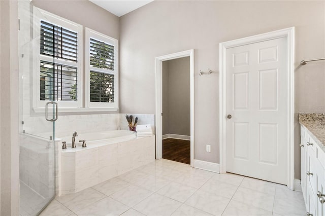 bathroom with vanity, plus walk in shower, and tile patterned flooring