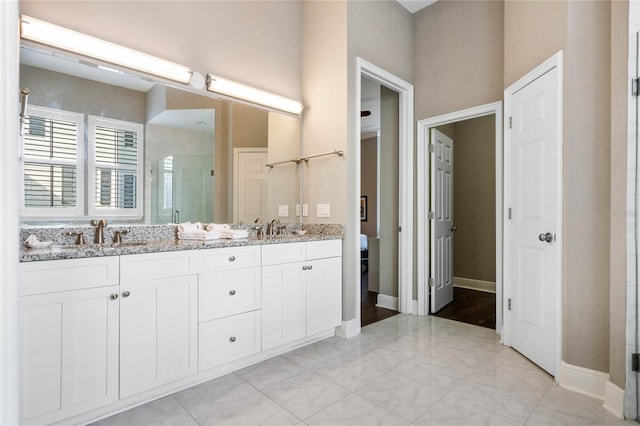 bathroom featuring vanity and a shower with shower door