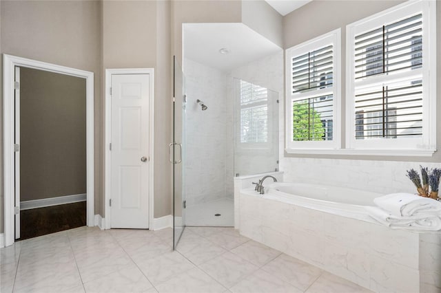 bathroom with shower with separate bathtub