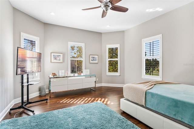 bedroom featuring multiple windows, ceiling fan, and dark hardwood / wood-style flooring