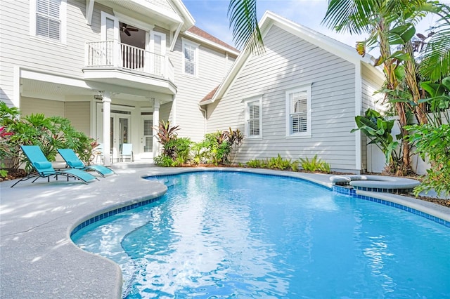 view of pool with an in ground hot tub and a patio