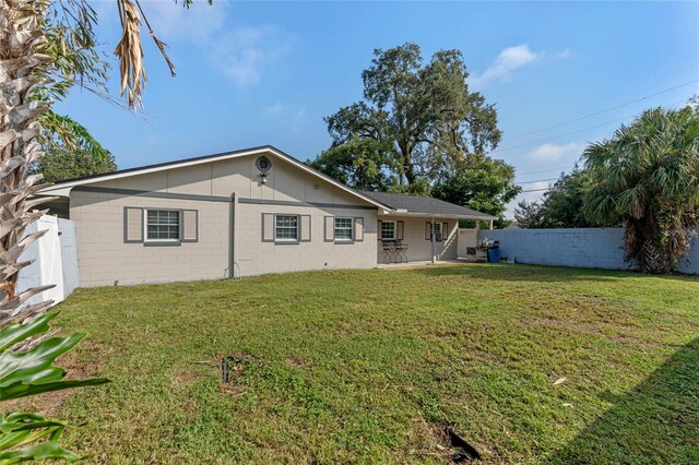 rear view of house with a yard