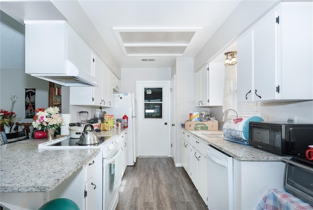 kitchen featuring light stone countertops, hardwood / wood-style floors, white cabinets, white appliances, and sink