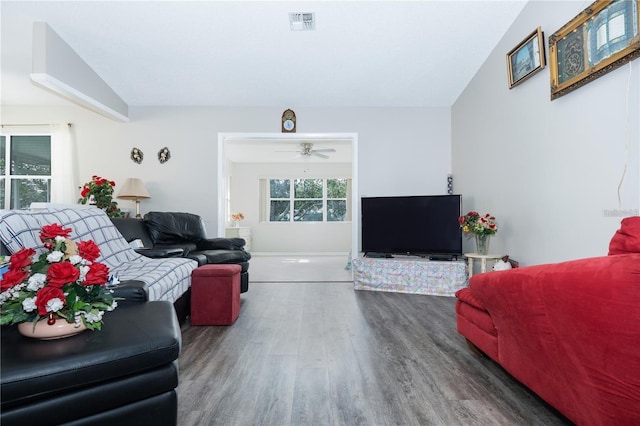 living room featuring ceiling fan, vaulted ceiling, and dark hardwood / wood-style flooring