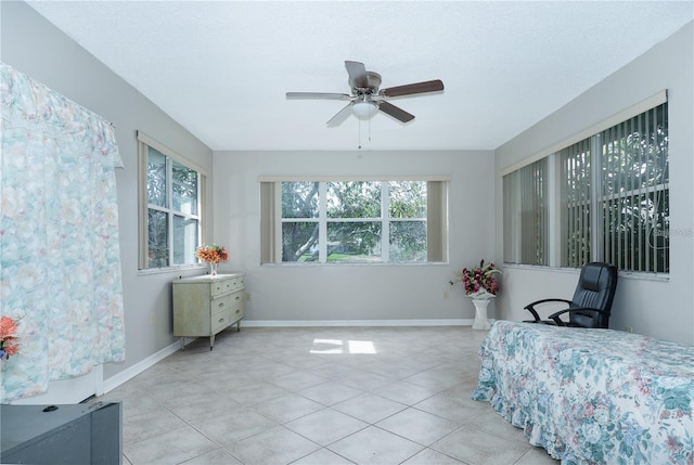 bedroom featuring ceiling fan and light tile patterned floors