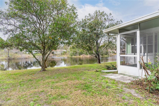 view of yard with a water view and a sunroom