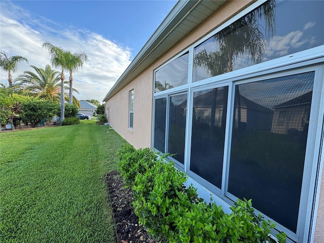 view of property exterior with a yard