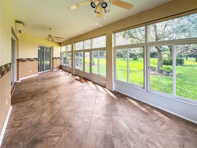 unfurnished sunroom featuring ceiling fan