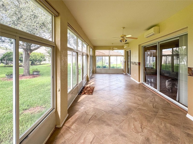 unfurnished sunroom featuring a wall mounted air conditioner, a healthy amount of sunlight, and ceiling fan