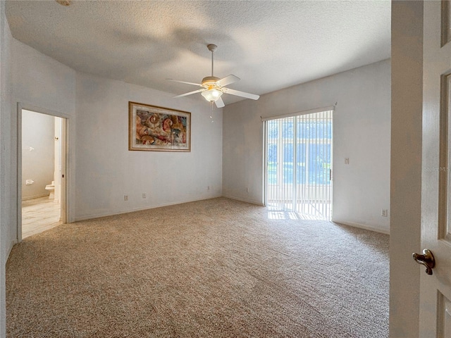 unfurnished room featuring light carpet, a textured ceiling, and ceiling fan