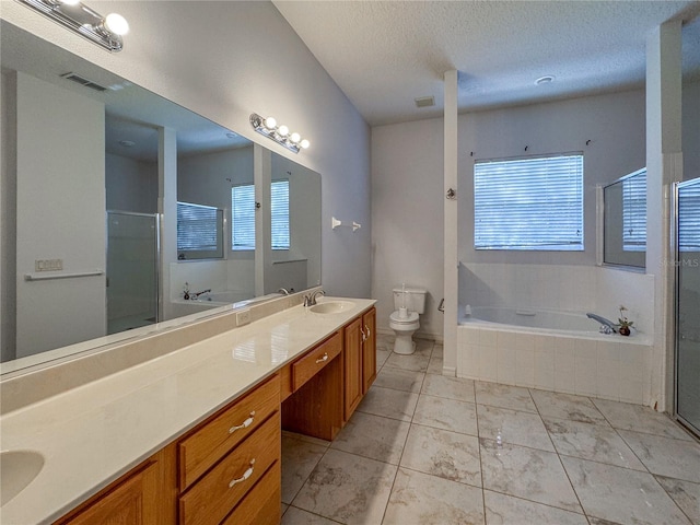 full bathroom featuring toilet, shower with separate bathtub, a healthy amount of sunlight, and vanity