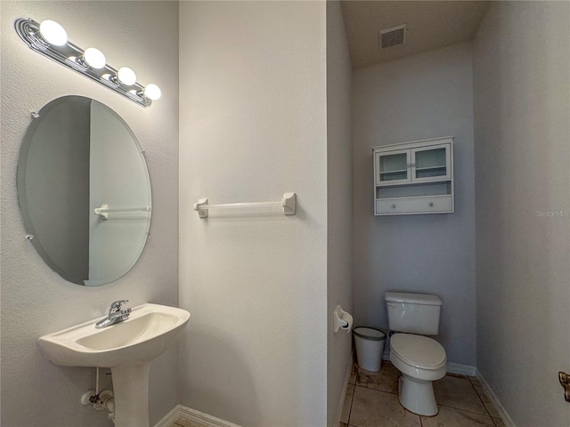 bathroom featuring tile patterned floors and toilet