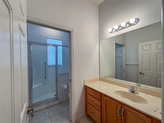 bathroom with toilet, an enclosed shower, vanity, and tile patterned flooring