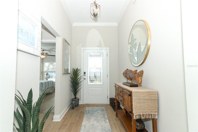 foyer featuring ceiling fan, crown molding, and light hardwood / wood-style floors