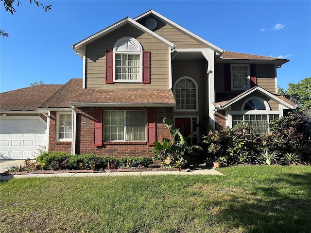 view of property featuring a front lawn and a garage