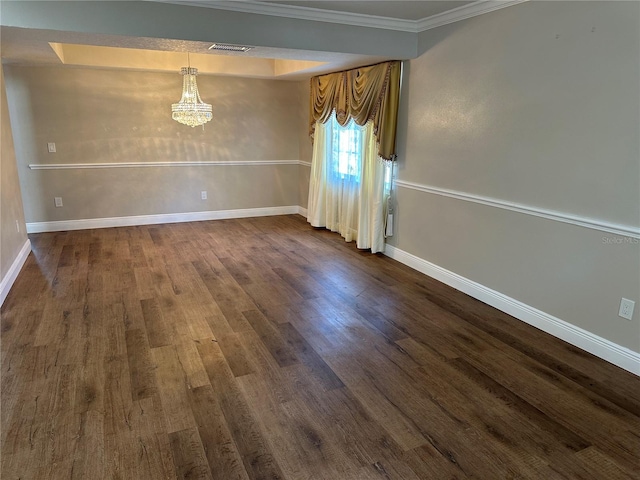 empty room featuring ornamental molding, a chandelier, and dark wood-type flooring