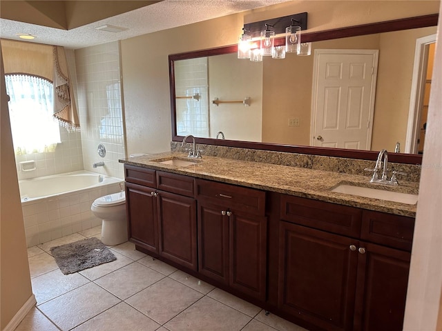 bathroom featuring toilet, tile patterned flooring, vanity, and a textured ceiling