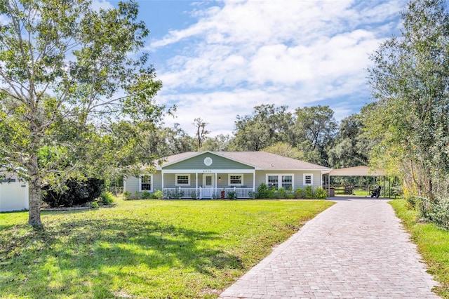 ranch-style home with a front yard and covered porch