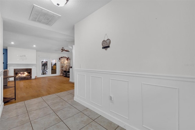 corridor featuring french doors and light hardwood / wood-style floors