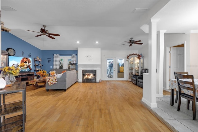 living room featuring ornate columns, french doors, light wood-type flooring, and ceiling fan