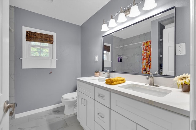 bathroom featuring vanity, walk in shower, and toilet