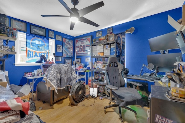 home office featuring hardwood / wood-style flooring and ceiling fan