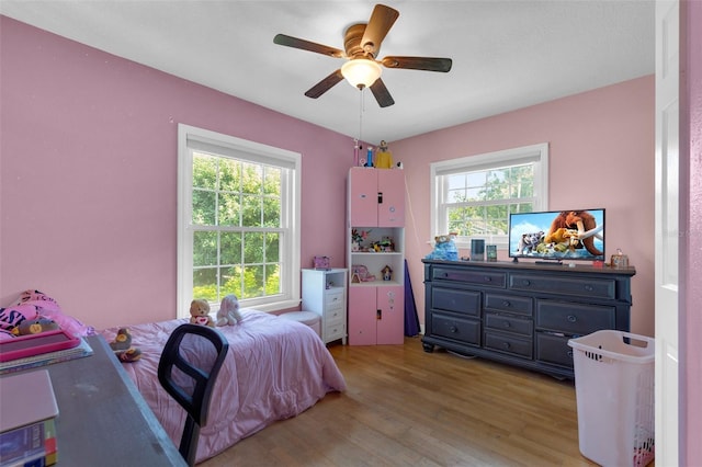 bedroom with ceiling fan and light hardwood / wood-style flooring