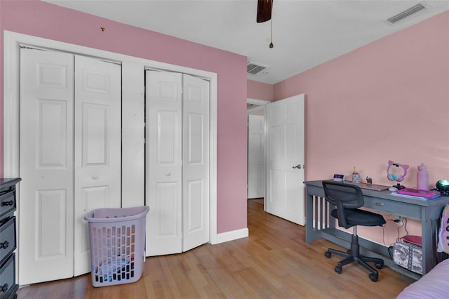 home office with ceiling fan and light hardwood / wood-style flooring