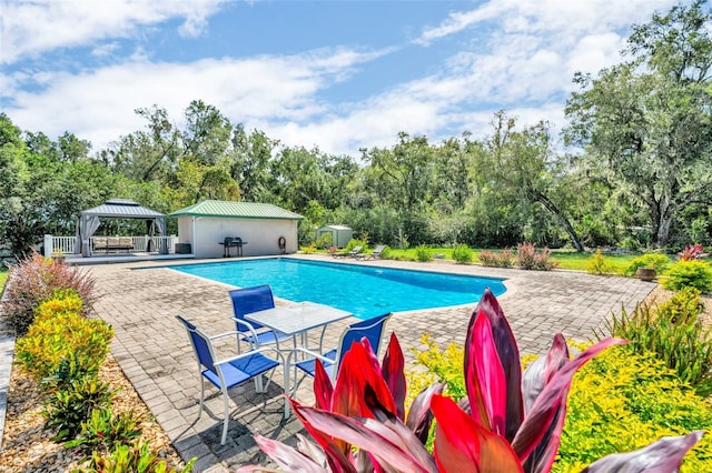 view of swimming pool with a gazebo and a patio area