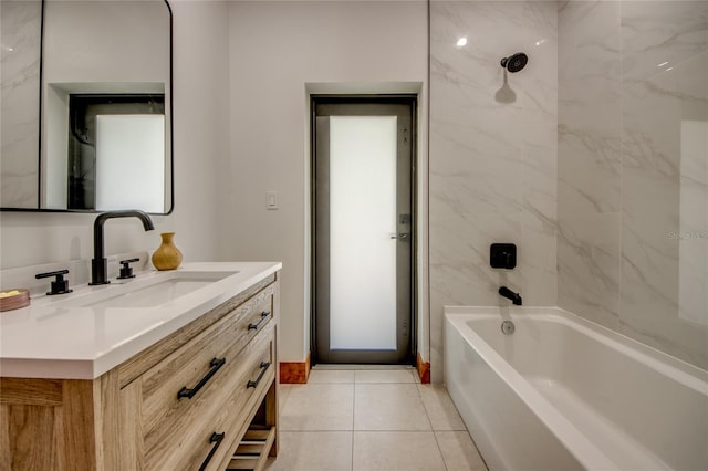 bathroom featuring tile patterned flooring, vanity, and tiled shower / bath