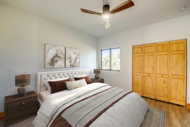 bedroom featuring ceiling fan, light hardwood / wood-style floors, and a closet