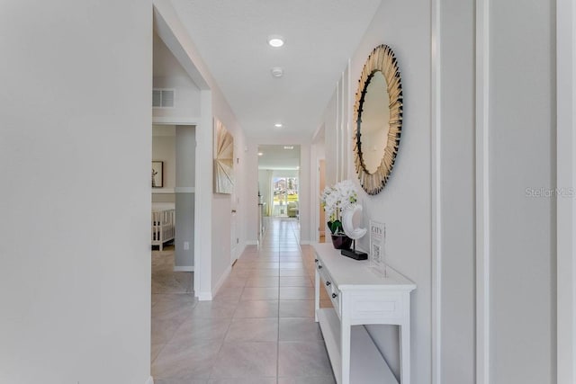 hallway featuring light tile patterned flooring and radiator heating unit