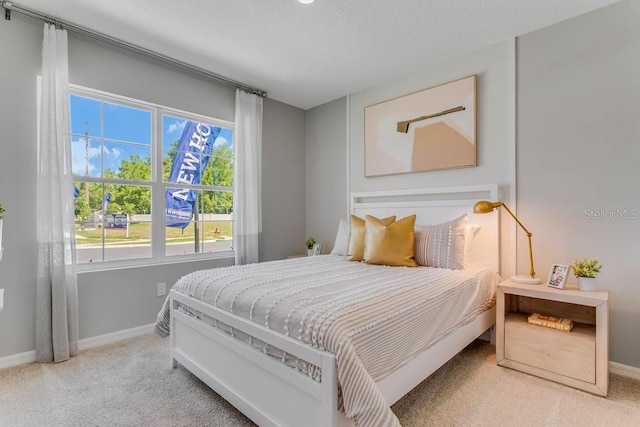 carpeted bedroom with a textured ceiling