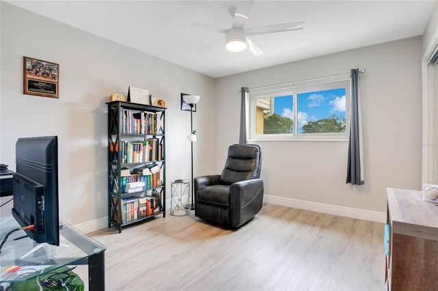 living area with light wood-type flooring and ceiling fan